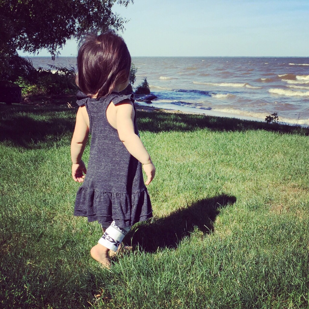 child playing near the ocean 