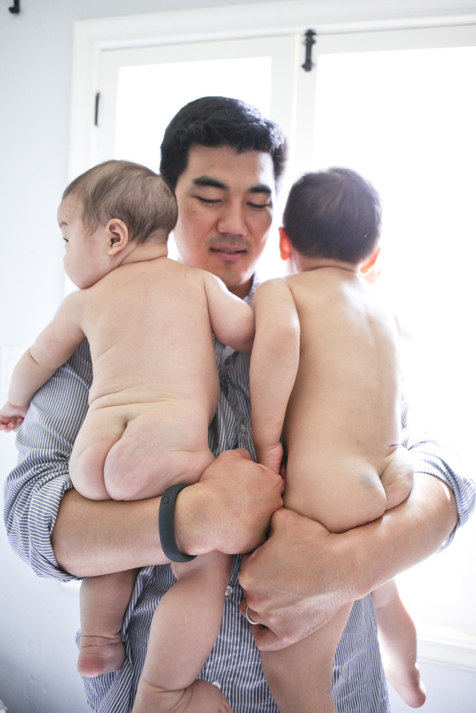 dad carrying two kids