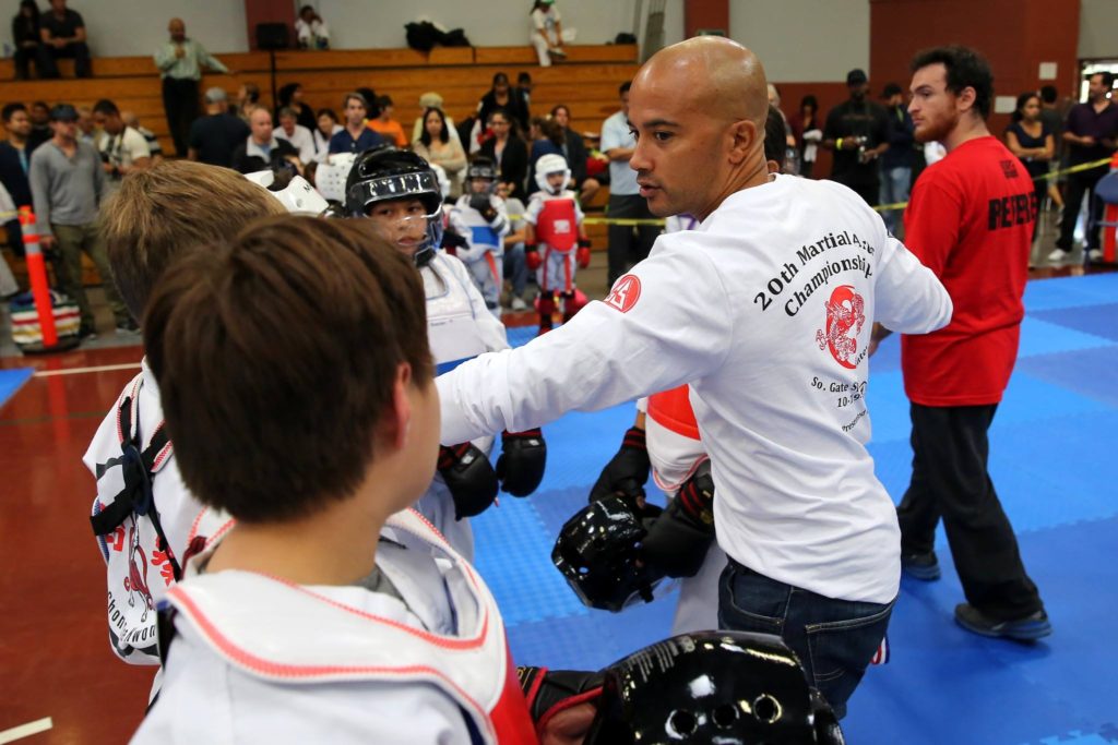 person teaching martial arts to kids