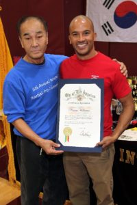 two people holding a certificate