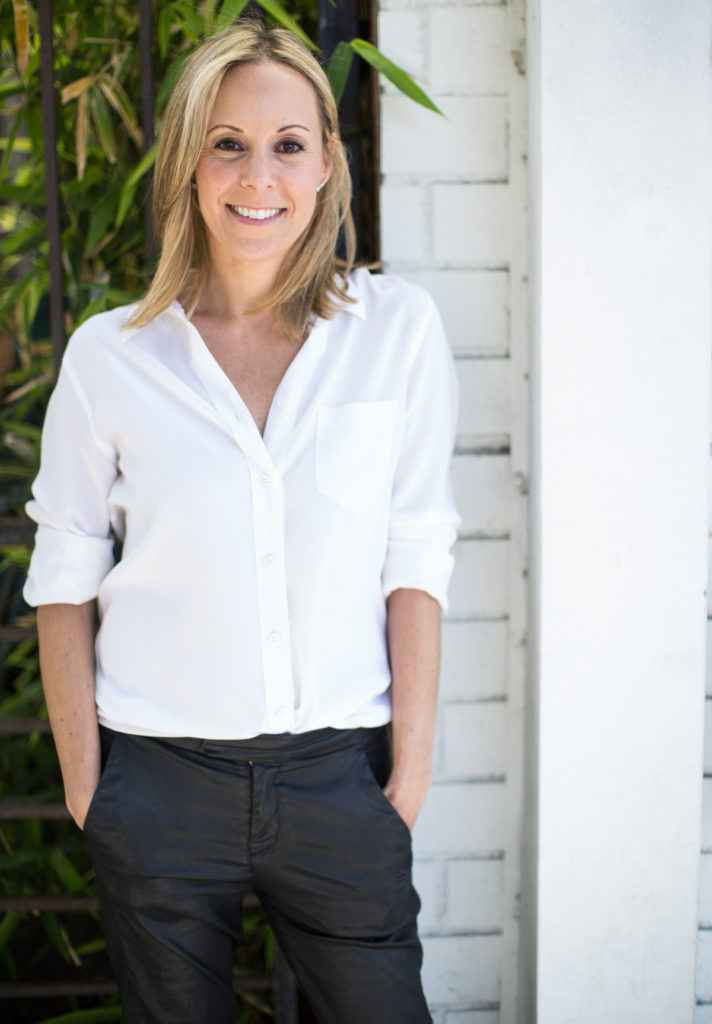 Celebrity Dietician Kim Shapira wearing white shirt and black pants