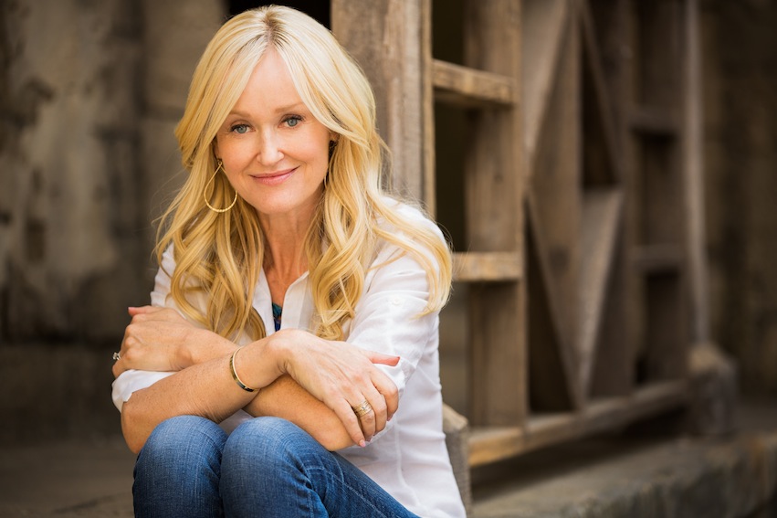 blond woman wearing jeans and white top