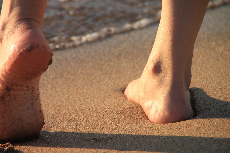 person walking at the beach