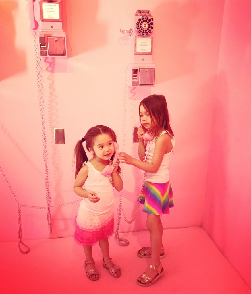 two kids using vintage telephone in MUSEUM OF ICE CREAM