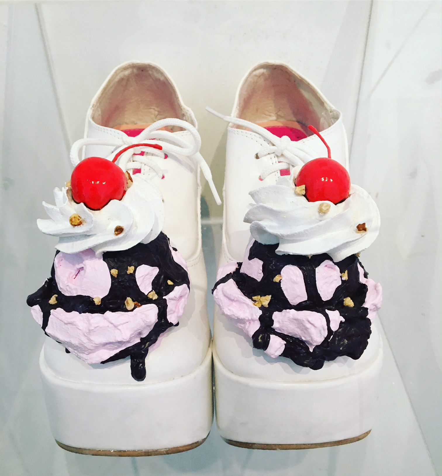 a pair of white shoes with ice cream 