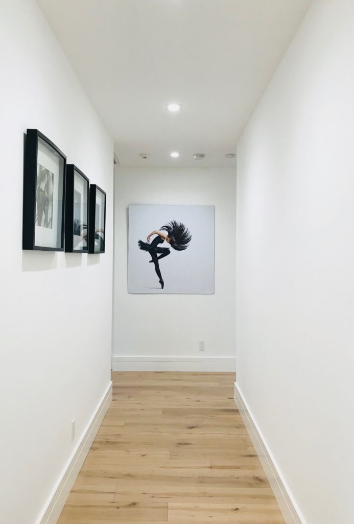 paintings on the wall of a hallway for feng shui during the holidays