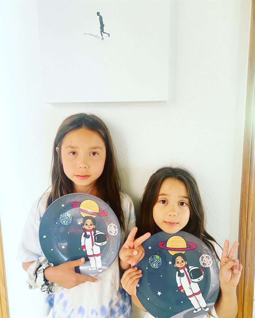 two kids holding colorful plates for back to school essentials